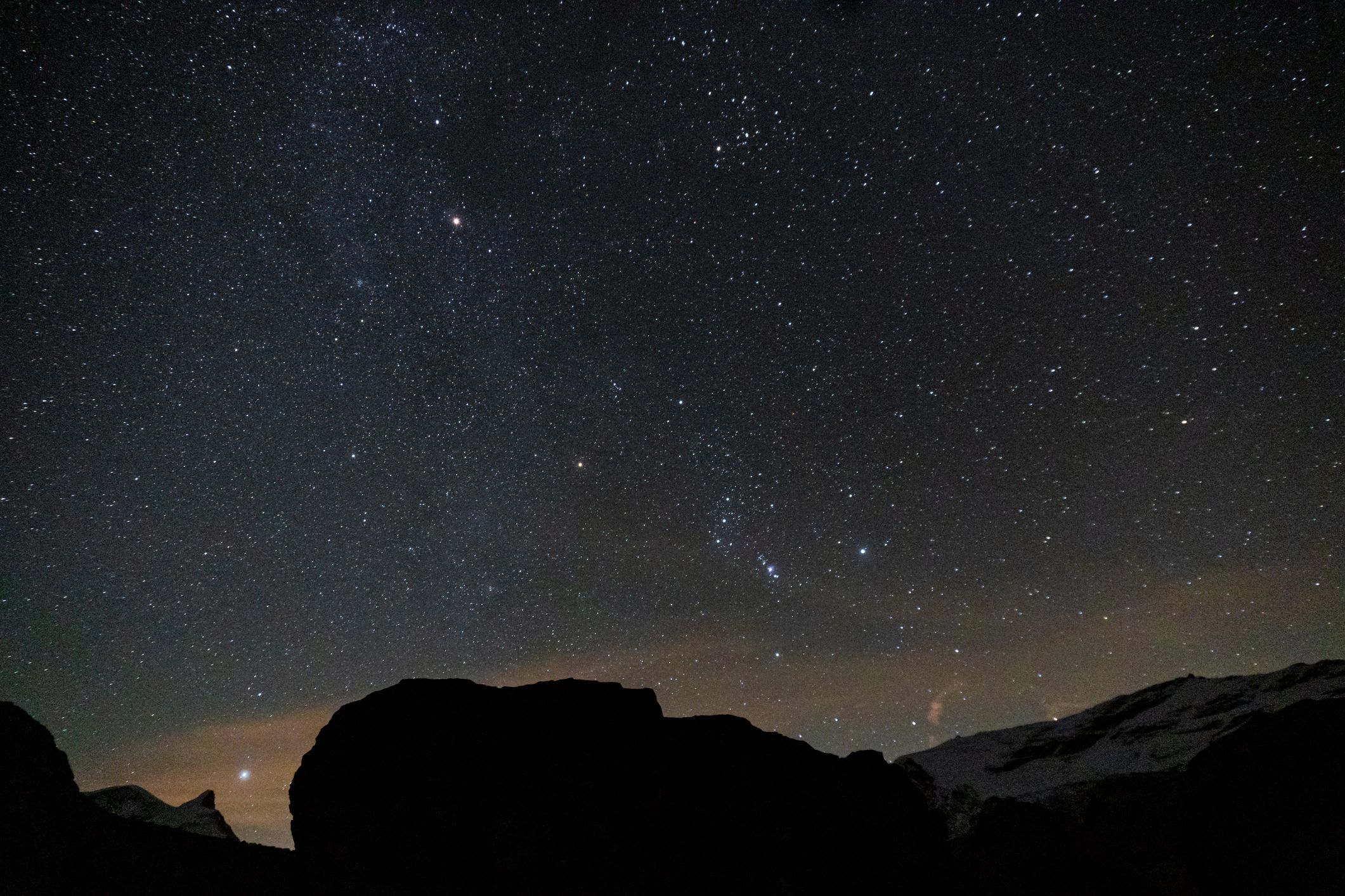 Night sky and stars above mountains